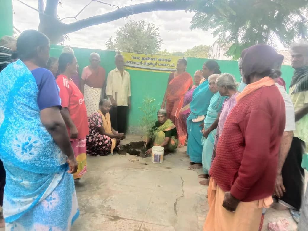 Residents queuing with bowls for a meal