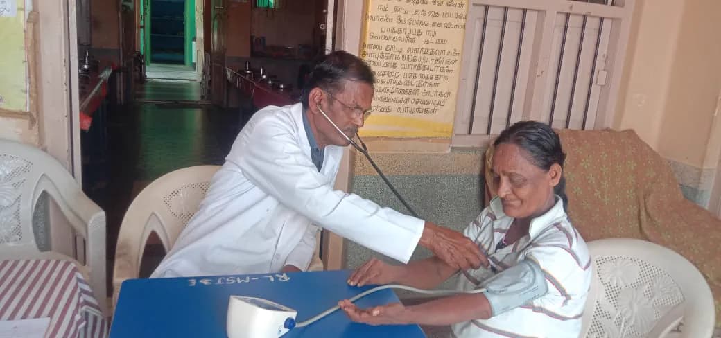 A doctor examining a resident at the home